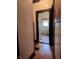 Hallway view into a bathroom with toilet, sink and a window with coverings at 3745 Winthrop Ave, Indianapolis, IN 46205