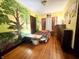 Unique bedroom with a whimsical tree mural and hardwood floors at 3745 Winthrop Ave, Indianapolis, IN 46205