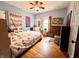 Bedroom with hardwood floors, a ceiling fan, and large windows at 3745 Winthrop Ave, Indianapolis, IN 46205