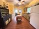 Charming kitchen with yellow walls, vintage cabinets, and a cozy breakfast nook at 3745 Winthrop Ave, Indianapolis, IN 46205
