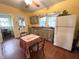 Bright and sunny kitchen featuring laminate floors, traditional cabinetry, and a cozy eating area at 3745 Winthrop Ave, Indianapolis, IN 46205