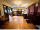 Spacious living room with hardwood floors, a fireplace and views into the office and front entry at 3745 Winthrop Ave, Indianapolis, IN 46205