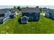 Aerial view of the property with a large green lawn and other homes in the neighborhood at 3980 Railhead Ave, Westfield, IN 46074