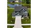 Beautiful home with gray siding, a large yard, and a pond with a fountain in the backyard at 3980 Railhead Ave, Westfield, IN 46074