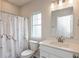 Bathroom featuring a marble-patterned shower curtain, a vanity with a large mirror, and a window for natural light at 3980 Railhead Ave, Westfield, IN 46074