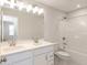 Bright bathroom featuring a double vanity, a large mirror, and a shower-tub combination with white tile surround at 3980 Railhead Ave, Westfield, IN 46074