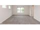 Spacious bedroom with plush carpet, large windows overlooking a serene pond with fountain, and neutral wall colors at 3980 Railhead Ave, Westfield, IN 46074