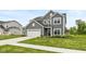 A charming two-story home with gray siding, a white garage door, and a well-maintained lawn at 3980 Railhead Ave, Westfield, IN 46074