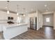 Modern kitchen with white cabinets, stainless steel appliances, and a large center island at 3980 Railhead Ave, Westfield, IN 46074