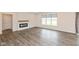 Bright living room with hardwood floors, a fireplace, and a large window with backyard views at 3980 Railhead Ave, Westfield, IN 46074
