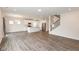 Spacious living room with hardwood floors, a modern staircase, and an open view of the kitchen at 3980 Railhead Ave, Westfield, IN 46074