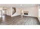 Open-concept living space with hardwood floors, a fireplace, and a modern kitchen at 3980 Railhead Ave, Westfield, IN 46074