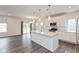 A modern kitchen featuring a center island that opens to a living room with hardwood floors at 3980 Railhead Ave, Westfield, IN 46074