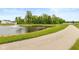 Scenic view of a community pond with a fountain, lush greenery, and a walking path, enhancing the neighborhood's charm at 3980 Railhead Ave, Westfield, IN 46074