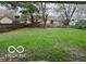 Expansive backyard featuring lush green grass and a wooden privacy fence at 4108 Steinmetz Dr, Indianapolis, IN 46254