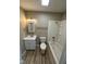 This bathroom features a shower-tub combo, updated fixtures, vanity with sink, and vinyl floors at 4108 Steinmetz Dr, Indianapolis, IN 46254
