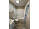 This bathroom features a shower-tub combo, vinyl floors, and neutral wall paint at 4108 Steinmetz Dr, Indianapolis, IN 46254