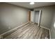 This bedroom features neutral wall paint, vinyl floors, closet, and bright overhead lighting at 4108 Steinmetz Dr, Indianapolis, IN 46254