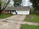 Charming single-story home with a well-manicured lawn and a two-car attached garage at 4108 Steinmetz Dr, Indianapolis, IN 46254