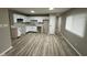 Bright kitchen with white cabinets, modern countertops, and laminate flooring at 4108 Steinmetz Dr, Indianapolis, IN 46254