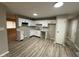 Open kitchen featuring white cabinets, modern countertops and laminate flooring at 4108 Steinmetz Dr, Indianapolis, IN 46254