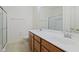 Well-lit bathroom with double sinks, tile flooring, glass-enclosed shower, and modern fixtures at 4261 Washington Blvd, Plainfield, IN 46168