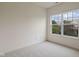 This bedroom has neutral carpet, a window, and white walls at 4261 Washington Blvd, Plainfield, IN 46168