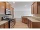 Well-lit kitchen with stainless steel appliances, light counter tops, and wood cabinets at 4261 Washington Blvd, Plainfield, IN 46168