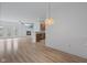 Open concept living room with hardwood flooring, fireplace, ceiling fan, and view of the kitchen at 4261 Washington Blvd, Plainfield, IN 46168