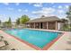 Community pool with red brick trim, white metal fence, covered patio with tables and chairs at 4261 Washington Blvd, Plainfield, IN 46168