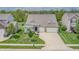 A beautiful aerial view of the house with a well-maintained lawn and driveway at 4428 Maldenhair Dr, Indianapolis, IN 46239