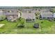 Aerial view of a home showcasing the large backyard with a trampoline and neighborhood at 4428 Maldenhair Dr, Indianapolis, IN 46239