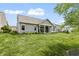 Spacious backyard featuring well-manicured lawn and a covered patio for outdoor enjoyment at 4428 Maldenhair Dr, Indianapolis, IN 46239