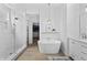 This bright bathroom boasts a glass shower and a soaking tub at 4428 Maldenhair Dr, Indianapolis, IN 46239