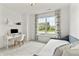 Bright bedroom features large window, desk and comfortable daybed with white walls at 4428 Maldenhair Dr, Indianapolis, IN 46239