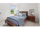 Cozy bedroom featuring a wooden bed frame, blue bedding, and natural light from a window at 4428 Maldenhair Dr, Indianapolis, IN 46239