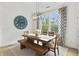 Inviting dining room with a rustic wooden table, bench seating, and a modern chandelier for stylish gatherings at 4428 Maldenhair Dr, Indianapolis, IN 46239