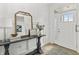 Bright entryway features light hardwood floors, stylish console table and paneled walls at 4428 Maldenhair Dr, Indianapolis, IN 46239