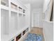 Hallway boasting a built-in mudroom area complete with storage shelves, coat hooks, and a cozy rug at 4428 Maldenhair Dr, Indianapolis, IN 46239