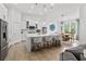 Bright, modern kitchen with an island, stainless steel appliances, and an adjacent dining area filled with natural light at 4428 Maldenhair Dr, Indianapolis, IN 46239