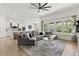 Open-concept living area with hardwood floors, comfortable seating, and an adjoining kitchen and dining space at 4428 Maldenhair Dr, Indianapolis, IN 46239
