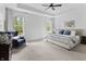 This main bedroom offers large windows, a tray ceiling, and neutral colors at 4428 Maldenhair Dr, Indianapolis, IN 46239