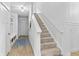 A naturally lit carpeted staircase leads to the upper level at 4428 Maldenhair Dr, Indianapolis, IN 46239
