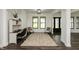 Bright foyer with stylish rug, black framed windows and doors, and a built-in desk at 4457 E County Road 850 N, Pittsboro, IN 46167