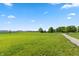 Beautiful, expansive front lawn featuring lush green grass, mature trees, and a private driveway at 4457 E County Road 850 N, Pittsboro, IN 46167