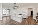 Spacious open-concept kitchen with quartz island, stainless appliances, and modern lighting at 4457 E County Road 850 N, Pittsboro, IN 46167