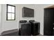 Laundry room featuring new front loading washer/dryer and ample cabinet space at 4457 E County Road 850 N, Pittsboro, IN 46167