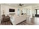 Cozy living room with hardwood floors, neutral-toned furniture, and a large TV at 4457 E County Road 850 N, Pittsboro, IN 46167