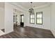 Open living space featuring hardwood floors, modern lighting, and large windows at 4457 E County Road 850 N, Pittsboro, IN 46167