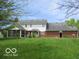 Expansive backyard with a screened porch and brick exterior at 4667 Sundance Trl, Indianapolis, IN 46239
